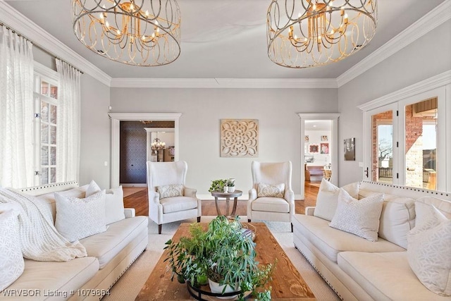 living area featuring crown molding, a notable chandelier, and wood finished floors