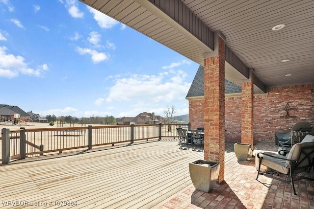 wooden deck featuring outdoor dining area