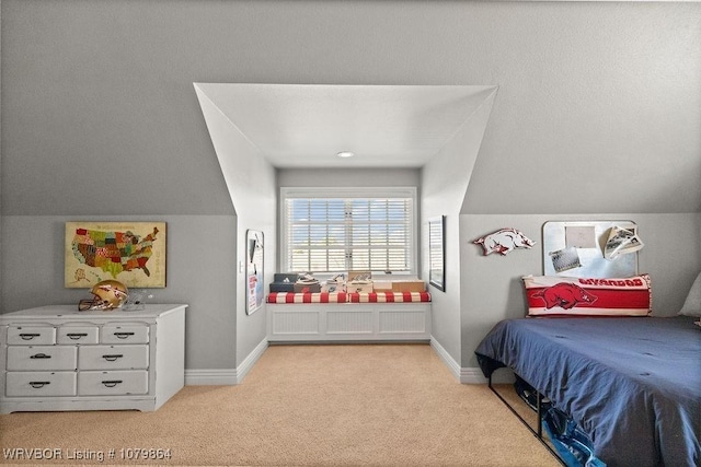 bedroom with light carpet, baseboards, and lofted ceiling