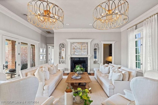 living area featuring a fireplace, crown molding, a chandelier, and visible vents