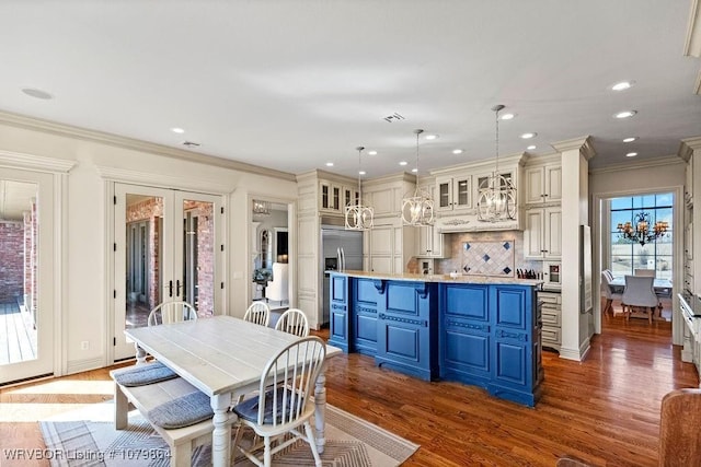 dining room featuring crown molding, recessed lighting, dark wood-type flooring, french doors, and a notable chandelier