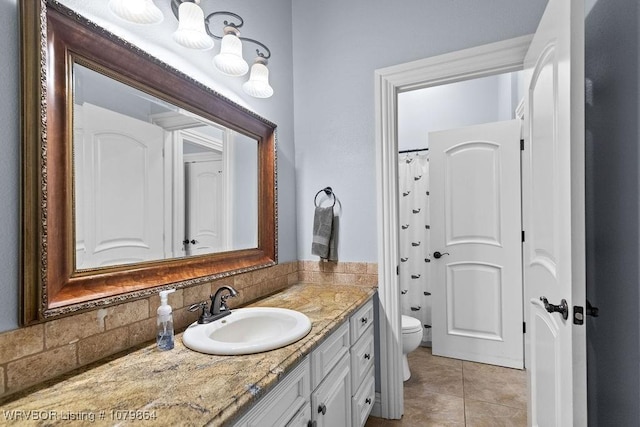 full bathroom with tile patterned floors, curtained shower, toilet, and vanity