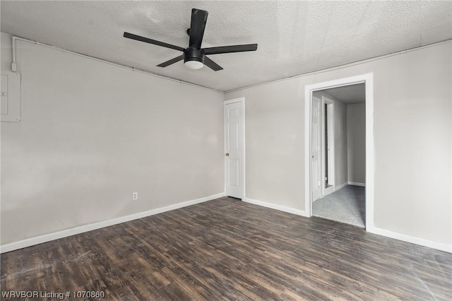 spare room with ceiling fan, a textured ceiling, and dark wood-type flooring