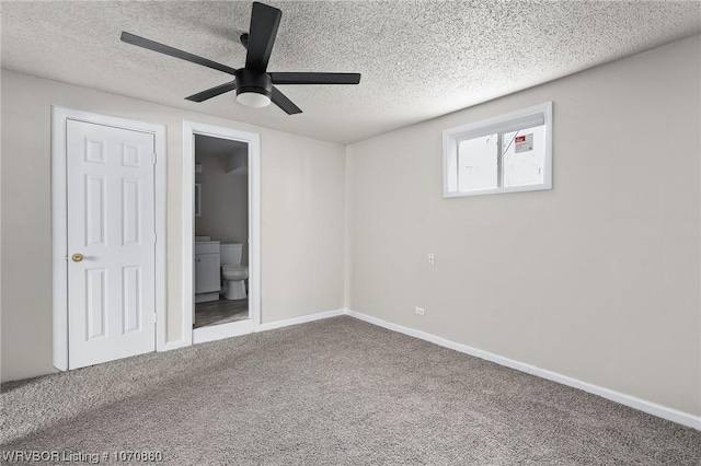 unfurnished bedroom featuring carpet flooring, ceiling fan, a textured ceiling, and ensuite bath