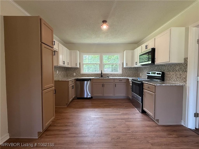 1505 E Main St, Lavaca, AR 72941 - kitchen featuring stainless steel appliances, a textured ceiling, dark wood-style floors, tasteful backsplash, and light countertops