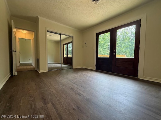 1505 E Main St, Lavaca, AR 72941 - foyer entrance featuring french doors, dark wood-style flooring, and a textured ceiling