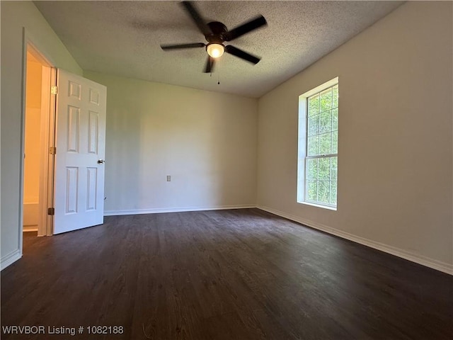 1505 E Main St, Lavaca, AR 72941 - unfurnished room with dark wood-style flooring, a textured ceiling, and a ceiling fan