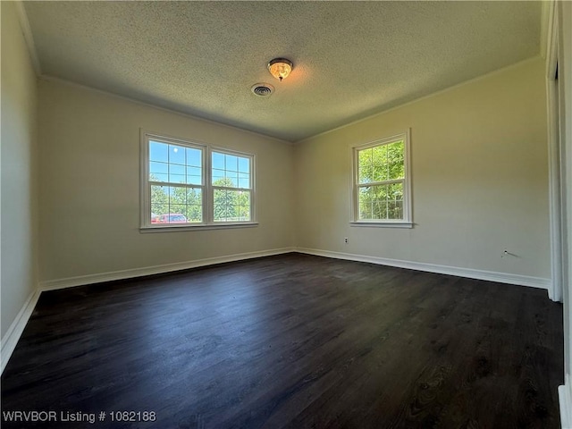 1505 E Main St, Lavaca, AR 72941 - empty room featuring a textured ceiling and dark wood-type flooring