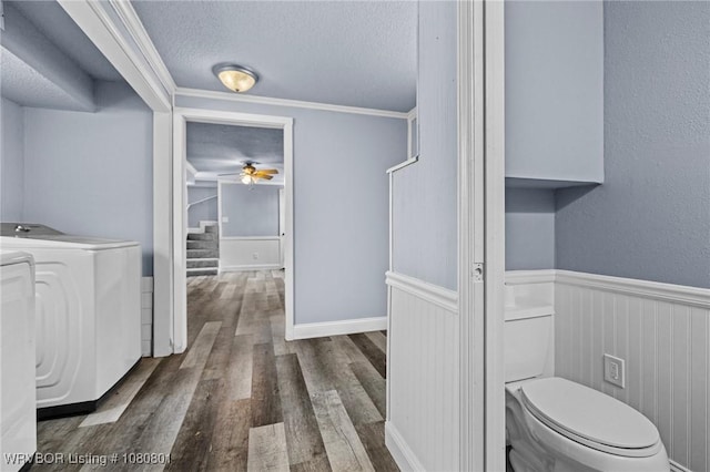 3815 Free Ferry Ln, Fort Smith, AR 72903 - laundry area with a textured ceiling, wood finished floors, separate washer and dryer, ceiling fan, and a wainscoted wall