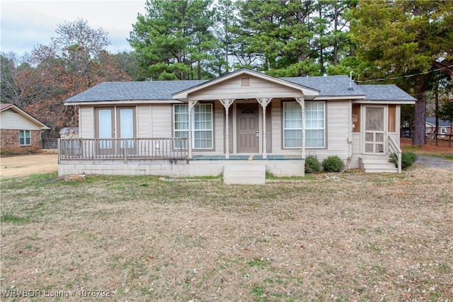 ranch-style house with a porch and a front lawn