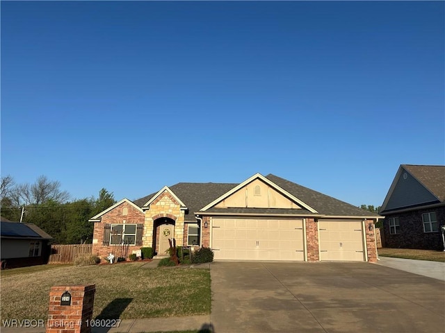 304 Caseys Ct, Lavaca, AR 72941 - view of front facade with concrete driveway, a front lawn, brick siding, a garage, and fence