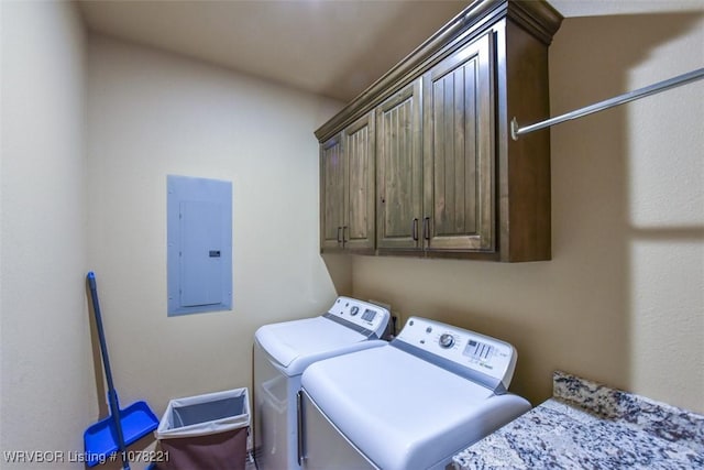 laundry area with cabinets, electric panel, and separate washer and dryer