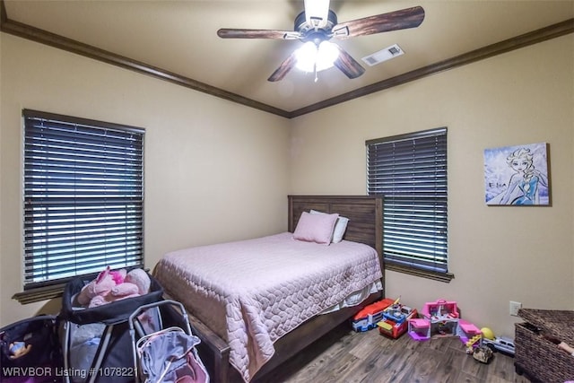 bedroom with hardwood / wood-style floors, ceiling fan, and crown molding