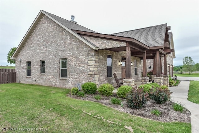 rear view of house with a yard