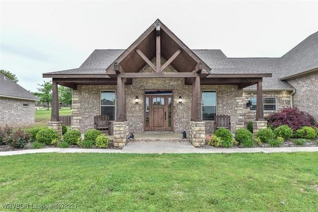 view of front of house with covered porch and a front lawn