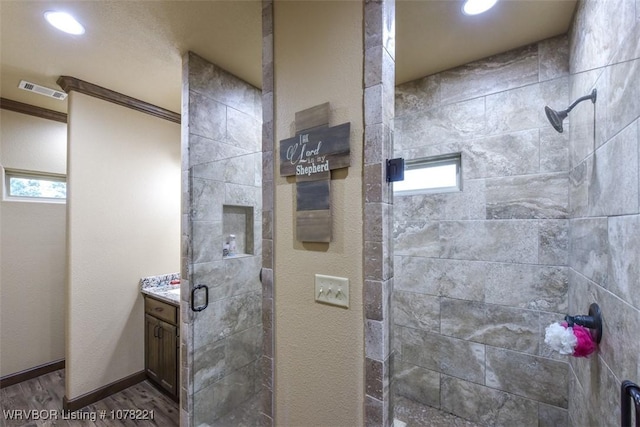 bathroom featuring vanity, an enclosed shower, wood-type flooring, and crown molding