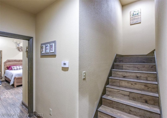 staircase featuring hardwood / wood-style floors