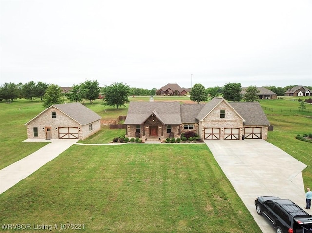 view of front of home with a garage and a front yard