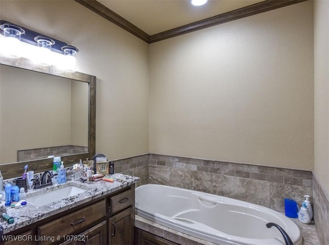 bathroom with a bath, vanity, and ornamental molding