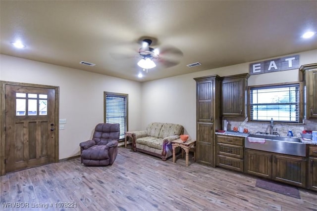 interior space with light hardwood / wood-style flooring, ceiling fan, and sink