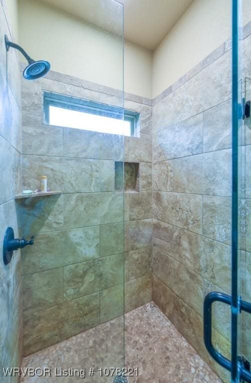 bathroom with a wealth of natural light and an enclosed shower