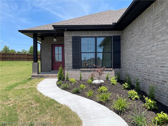 entrance to property featuring a yard