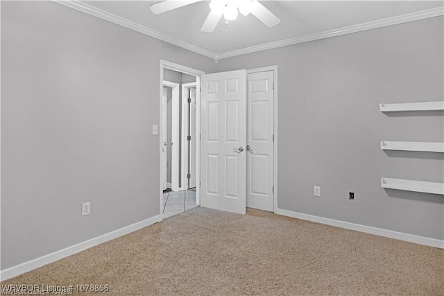 unfurnished bedroom with ornamental molding, light colored carpet, ceiling fan, and a closet