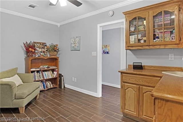 interior space with crown molding, sink, and ceiling fan