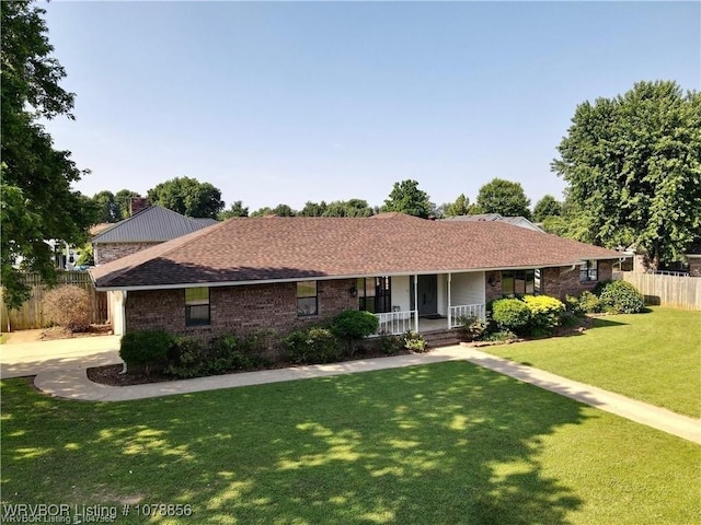 single story home featuring a porch and a front yard