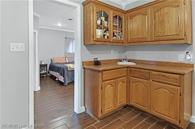 kitchen with crown molding and sink