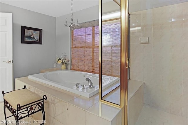 bathroom with separate shower and tub and an inviting chandelier