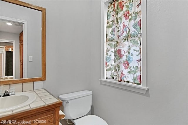 bathroom with vanity and toilet