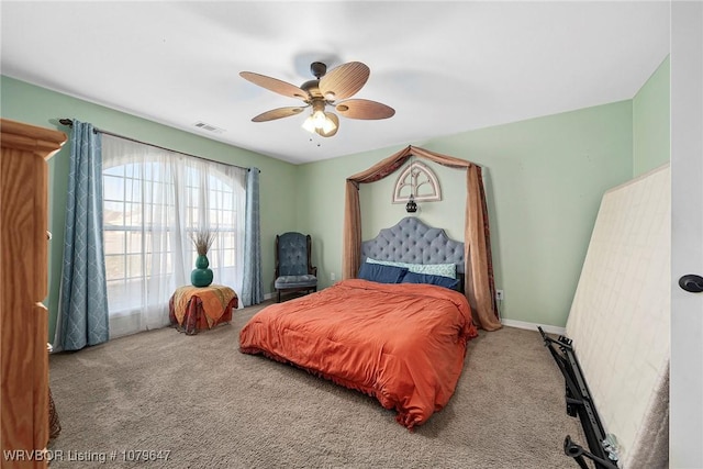carpeted bedroom with a ceiling fan, baseboards, and visible vents