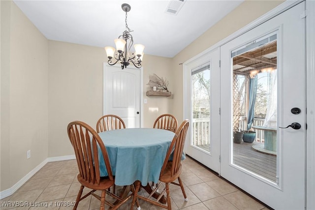 dining area featuring an inviting chandelier, light tile patterned flooring, baseboards, and visible vents