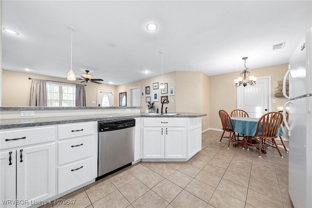 kitchen with visible vents, pendant lighting, stainless steel dishwasher, freestanding refrigerator, and light tile patterned floors