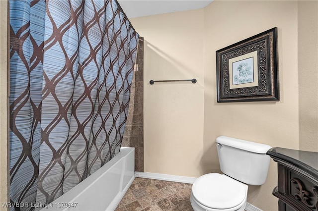 full bath with stone finish floor, toilet, baseboards, and shower / tub combo with curtain