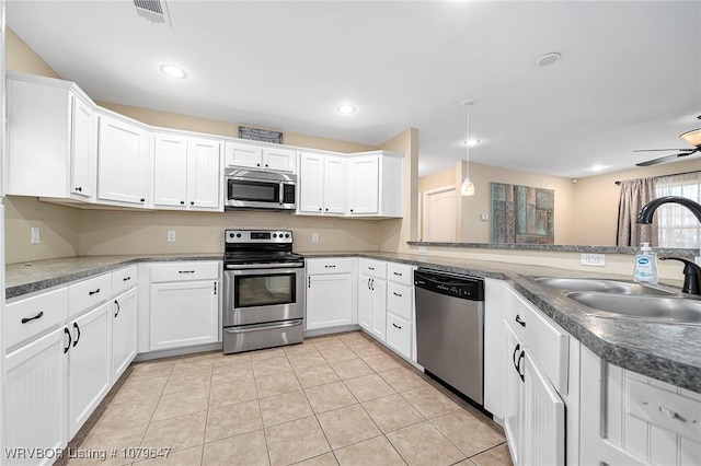 kitchen featuring white cabinets, visible vents, appliances with stainless steel finishes, and a sink