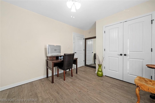 home office featuring baseboards and light wood-style floors