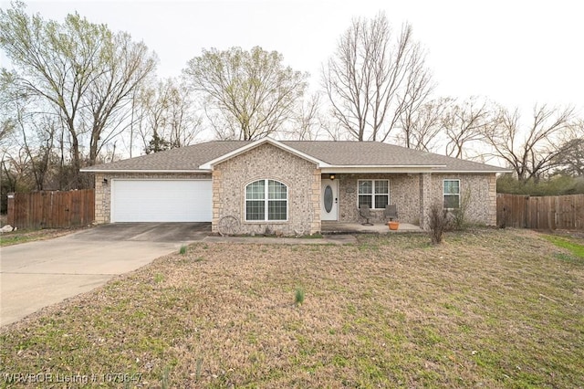 ranch-style house with a front lawn, fence, a garage, and driveway