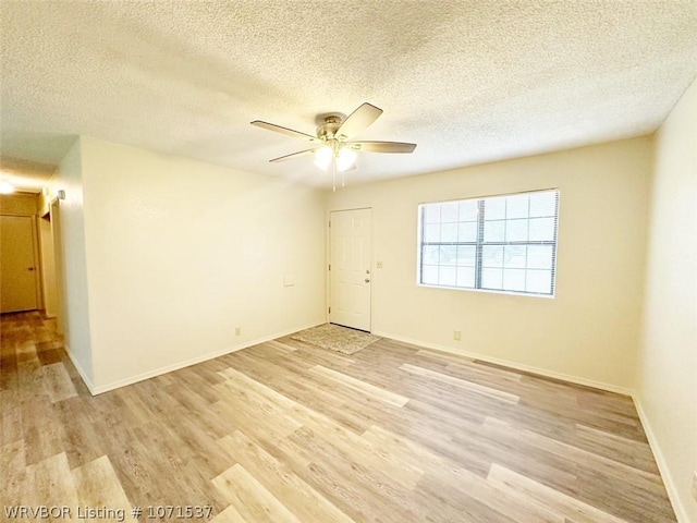 unfurnished room featuring a textured ceiling, light hardwood / wood-style flooring, and ceiling fan