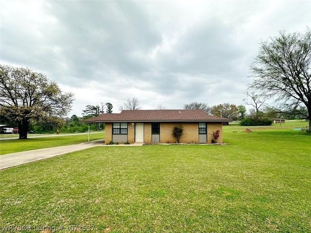 single story home featuring a front lawn and a carport