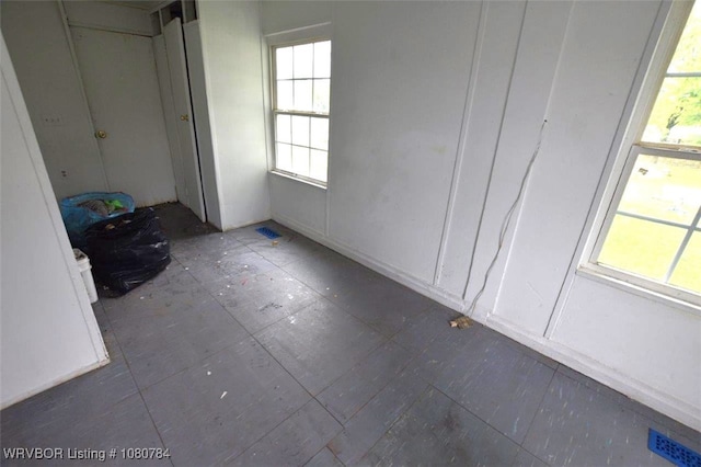 unfurnished bedroom with visible vents and multiple windows