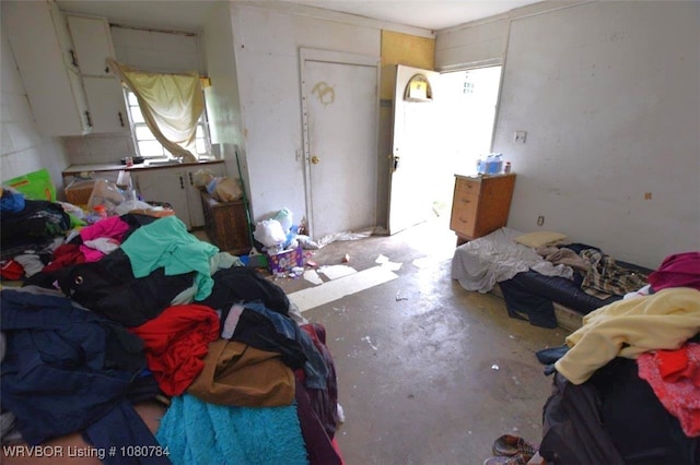 bedroom featuring unfinished concrete flooring