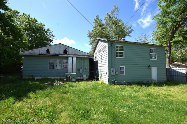 rear view of property featuring fence