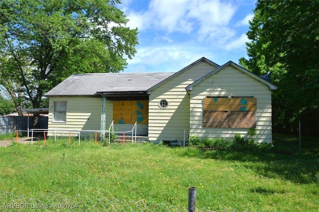 rear view of property with fence