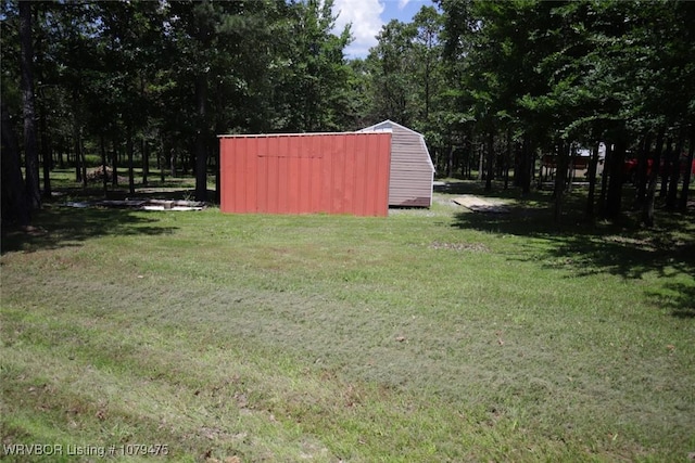 view of yard featuring an outbuilding and a storage shed