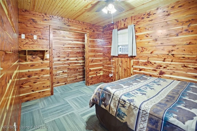 bedroom featuring wooden ceiling, wood walls, carpet floors, and ceiling fan