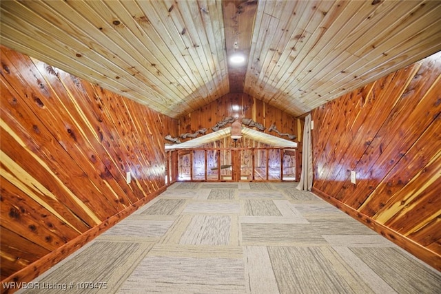 interior space featuring lofted ceiling, wooden walls, and wooden ceiling