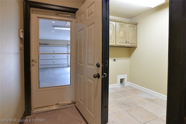 laundry room featuring cabinet space, electric dryer hookup, and baseboards