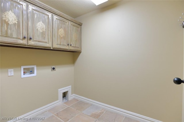 washroom featuring cabinet space, hookup for a washing machine, baseboards, and electric dryer hookup